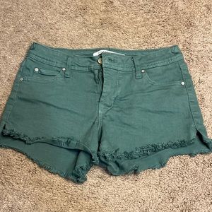 Teal jean shorts with fray edges